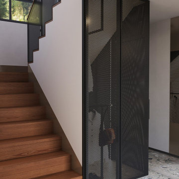 Oak-tread staircase with black perforated-metal screen, Kirkland WA