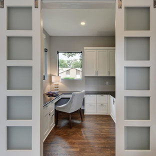 Inspiration for a medium sized modern study in Austin with grey walls, medium hardwood flooring and a built-in desk.