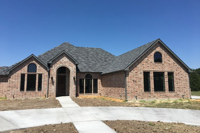 Mid-sized traditional brown one-story brick house exterior idea in Dallas