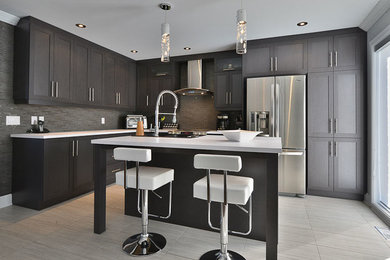 Inspiration for a mid-sized contemporary l-shaped ceramic tile open concept kitchen remodel in Montreal with an undermount sink, shaker cabinets, medium tone wood cabinets, quartzite countertops, brown backsplash, glass tile backsplash, stainless steel appliances and an island