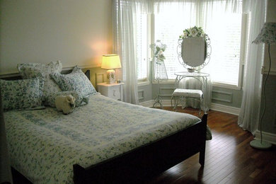 Example of a mid-sized mountain style guest dark wood floor bedroom design in Montreal with white walls