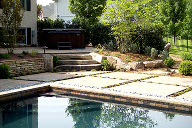 Example of a mid-sized classic backyard stone and rectangular lap pool design in Philadelphia