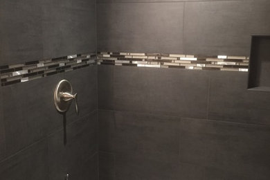 Small trendy master black tile and porcelain tile bathroom photo in Other