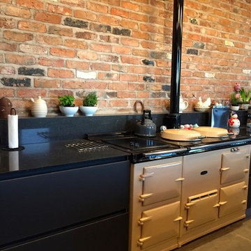 Next 125 Lava black matt glass and matt lacquer with Silestone Arden blue works
