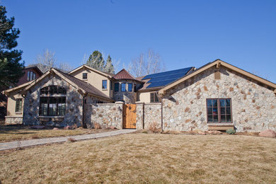 Large eclectic beige two-story stone exterior home photo in Denver with a shingle roof