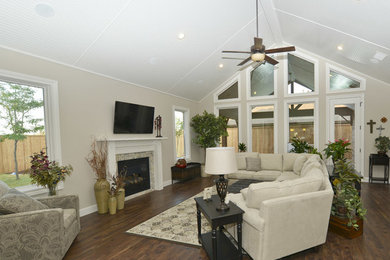 Example of a mid-sized transitional formal and enclosed medium tone wood floor living room design in Austin with beige walls, a standard fireplace, a tile fireplace and a wall-mounted tv