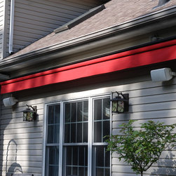 Solid Red Awning  Against The House. - Awnings