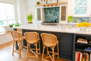 Inspiration for a mid-sized timeless light wood floor enclosed kitchen remodel in Other with a farmhouse sink, beaded inset cabinets, green cabinets, marble countertops, green backsplash, paneled appliances and an island