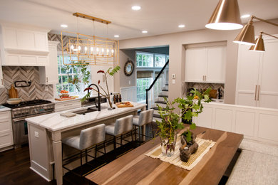 Example of a large beach style dark wood floor eat-in kitchen design in Other with an undermount sink, shaker cabinets, white cabinets, quartz countertops, multicolored backsplash, marble backsplash, stainless steel appliances, an island and white countertops