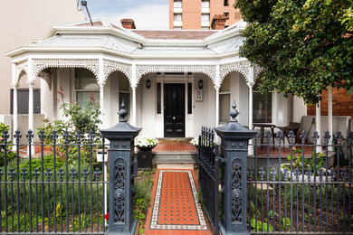 Mid-sized traditional one-storey white exterior in Melbourne with a hip roof and a mixed roof.