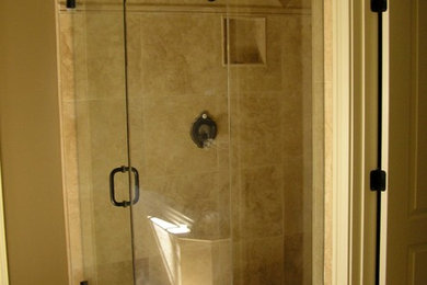 Inspiration for a mid-sized transitional 3/4 black tile and ceramic tile ceramic tile doorless shower remodel in Raleigh with black cabinets, a one-piece toilet, beige walls, a drop-in sink and granite countertops