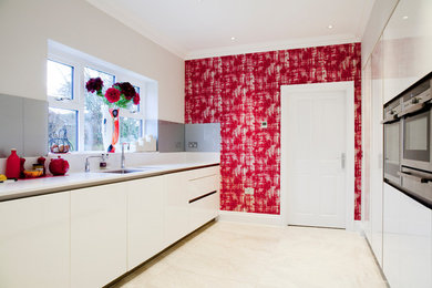 Inspiration for a contemporary kitchen in Cheshire with grey splashback and glass sheet splashback.