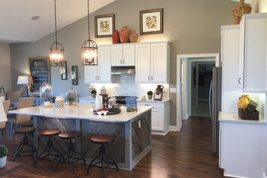 Example of a mid-sized farmhouse kitchen design in Other with an undermount sink, flat-panel cabinets, dark wood cabinets and stainless steel appliances
