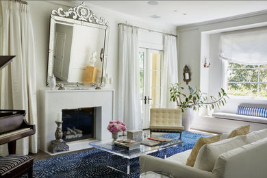 Large minimalist formal and enclosed medium tone wood floor and brown floor living room photo in Los Angeles with white walls and a standard fireplace
