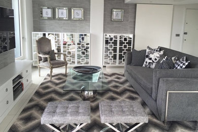 Inspiration for a mid-sized modern marble floor living room remodel in London with gray walls and a wall-mounted tv