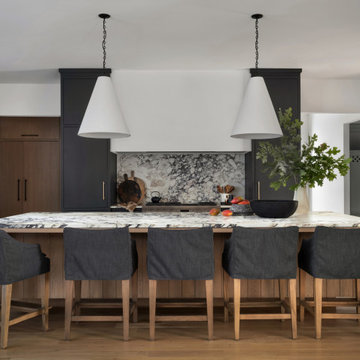 Moody Custom Kitchen with Black Cabinets, Marble Backsplash & Brass Hardware