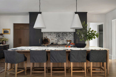 Kitchen - transitional kitchen idea in Atlanta with flat-panel cabinets, black cabinets, marble countertops, marble backsplash and an island