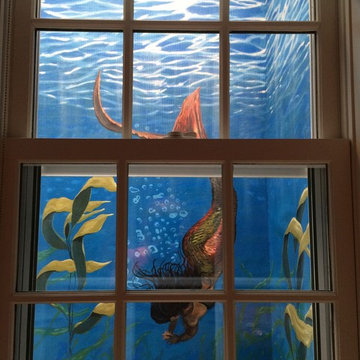 Mermaids in the window wells, painted by Miguel Hernandez