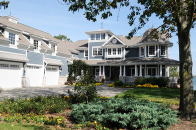 Inspiration for a large timeless blue three-story concrete exterior home remodel in Chicago