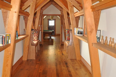 Large elegant medium tone wood floor and brown floor hallway photo in Denver with white walls