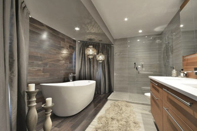 Trendy master gray tile and ceramic tile ceramic tile, gray floor, single-sink and wood wall bathroom photo in Montreal with furniture-like cabinets, light wood cabinets, a wall-mount toilet, gray walls, quartzite countertops, white countertops and a floating vanity