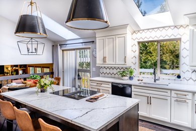 Transitional dark wood floor and brown floor eat-in kitchen photo in Portland with an undermount sink, shaker cabinets, white cabinets, white backsplash, black appliances, an island and white countertops