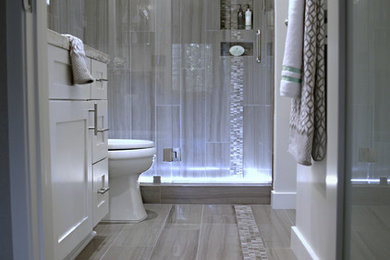 Example of a mid-sized trendy master gray tile and mosaic tile marble floor bathroom design in San Diego with an undermount sink, shaker cabinets, white cabinets, solid surface countertops, a two-piece toilet and gray walls