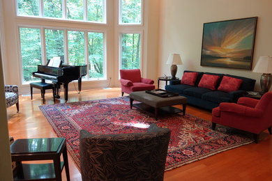Living room - large traditional formal and enclosed light wood floor living room idea in Grand Rapids with yellow walls, a standard fireplace, a stone fireplace and no tv