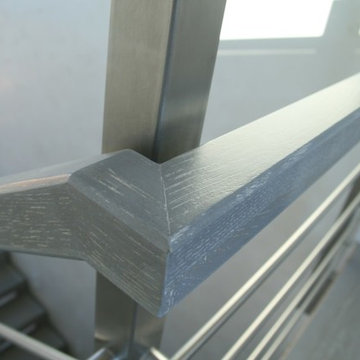 Modern metal stair covered by patina oak