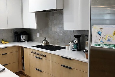 Inspiration for a large modern l-shaped eat-in kitchen remodel in Boston with flat-panel cabinets, light wood cabinets, granite countertops and an island