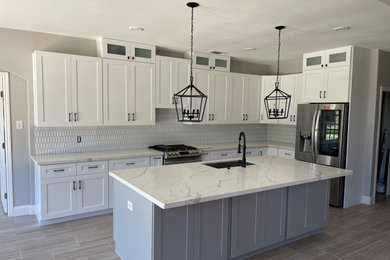 Example of a large trendy porcelain tile and beige floor kitchen design in Houston with shaker cabinets, white cabinets, quartz countertops, white backsplash and white countertops