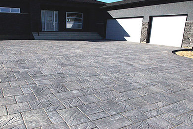 Inspiration for a huge modern front yard driveway in Other.