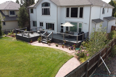 Inspiration for a mid-sized backyard mixed material railing deck remodel in Denver