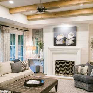 Large traditional walk-out basement in Atlanta with white walls, light hardwood flooring, a standard fireplace, a concrete fireplace surround and brown floors.
