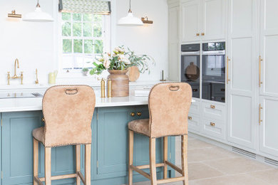 Photo of a medium sized kitchen/diner in Other with limestone flooring and an island.