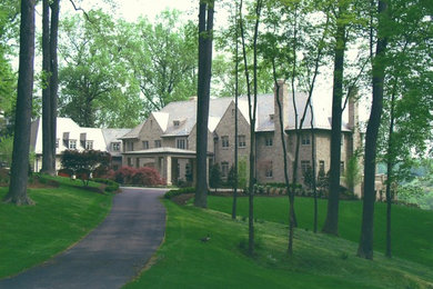 Large traditional beige three-story stone exterior home idea in Richmond