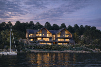 Design ideas for an expansive and gey modern rear house exterior in Cornwall with three floors, wood cladding, a pitched roof, a tiled roof, a grey roof and board and batten cladding.