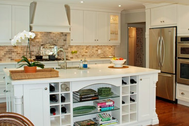 Open concept kitchen - large transitional l-shaped medium tone wood floor open concept kitchen idea in Toronto with a double-bowl sink, shaker cabinets, white cabinets, quartz countertops, multicolored backsplash, subway tile backsplash, stainless steel appliances and an island