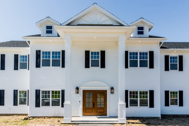 Huge white two-story vinyl exterior home photo in Other with a shingle roof