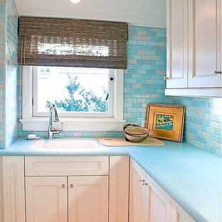 Inspiration for a large traditional l-shaped separated utility room in San Diego with a submerged sink, shaker cabinets, white cabinets, glass worktops, white walls, porcelain flooring and a side by side washer and dryer.