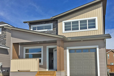 Example of a mid-sized trendy two-story mixed siding exterior home design in Toronto