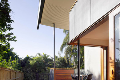 Contemporary two-storey white exterior in Brisbane with wood siding.