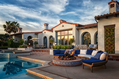 Patio - mediterranean backyard patio idea in San Diego with a fire pit and no cover