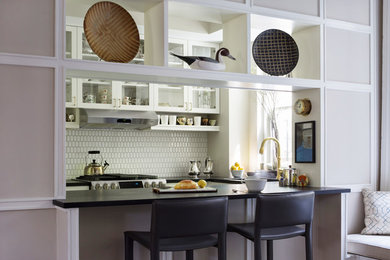 Inspiration for a small transitional galley separate kitchen in New York with glass-front cabinets and no island.