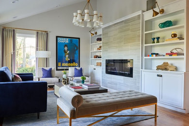Transitional medium tone wood floor and brown floor living room photo in New York with beige walls and a ribbon fireplace