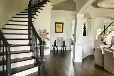 Example of a large eclectic dark wood floor and brown floor entryway design in Nashville with white walls and a metal front door