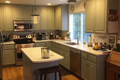 Mid-sized elegant u-shaped medium tone wood floor and brown floor eat-in kitchen photo in Seattle with a double-bowl sink, raised-panel cabinets, gray cabinets, quartzite countertops, stainless steel appliances and an island