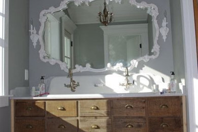 Example of a mid-sized transitional master medium tone wood floor bathroom design in San Diego with furniture-like cabinets, medium tone wood cabinets, gray walls and a drop-in sink