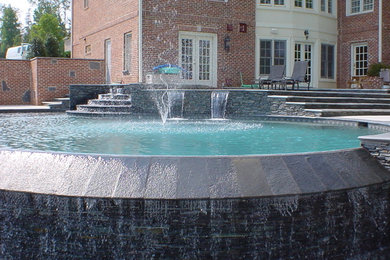 Inspiration for a timeless backyard custom-shaped infinity pool fountain remodel in Atlanta