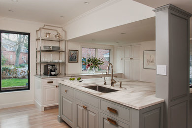 Huge eat-in kitchen photo in DC Metro with marble countertops and an island
